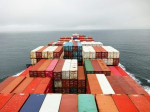 Shipping containers on a boat in the ocean. Imports will now face fees for carbon emissions under the CBAM.